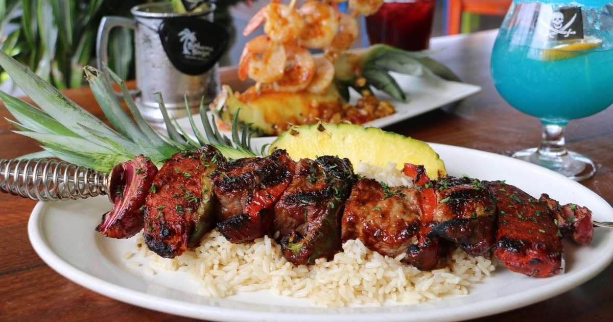 A meat skewer with rice and pineapple from Bahama Breeze