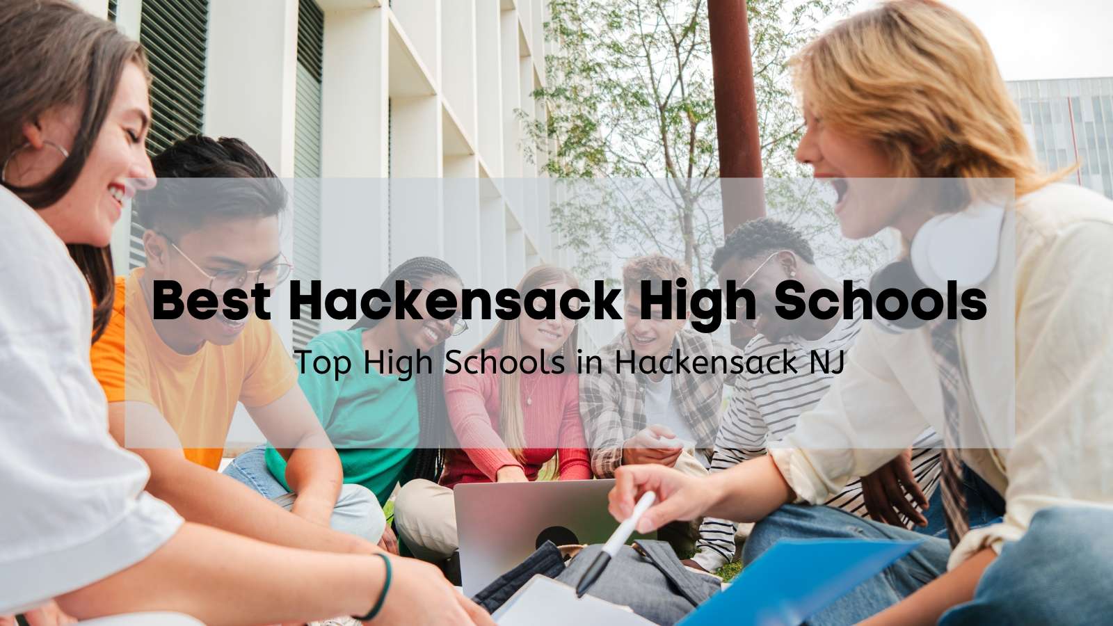 Group of high school students at a Hackensack high school sitting on the grass studying.