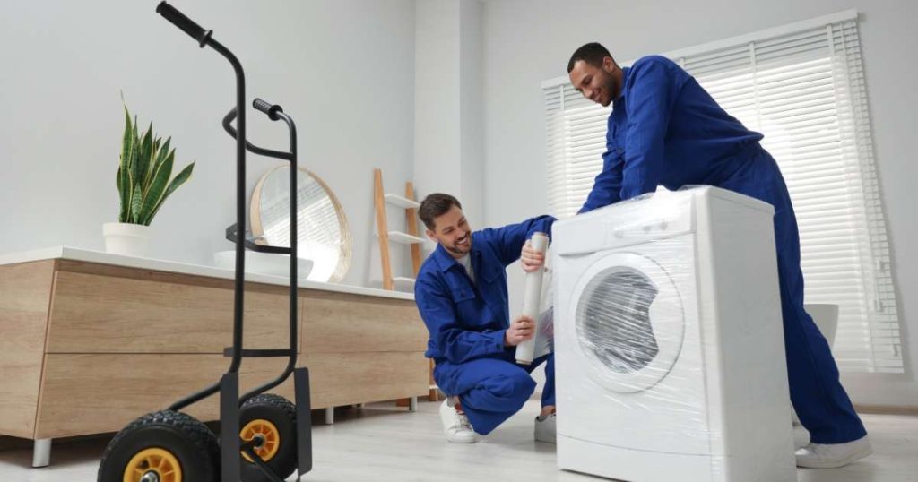 Hasbrouck Heights movers wrapping an appliance. 