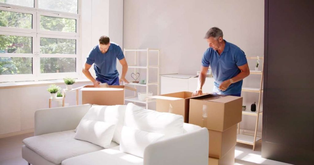 Ridgefield movers in blue polo shirts packing boxes in a home