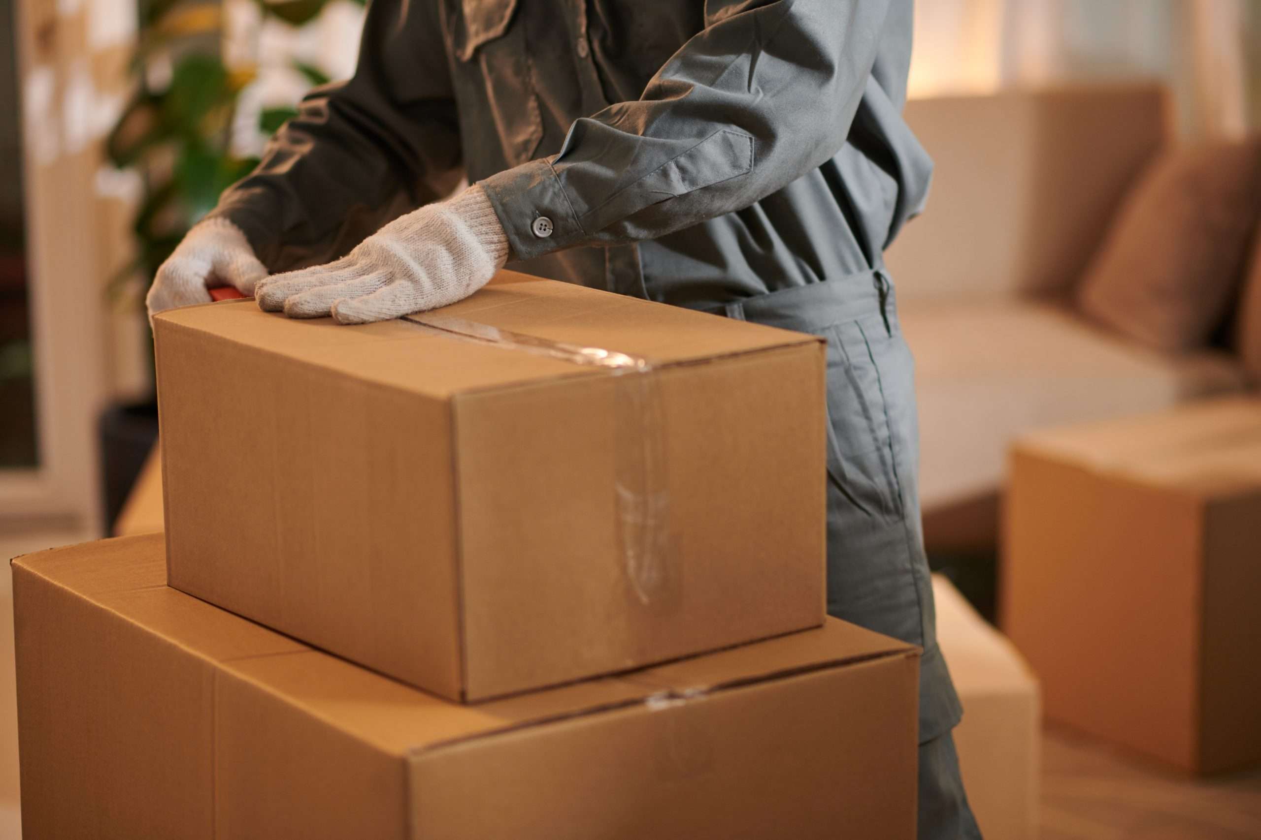 A Mover in Wyckoff taping up a box 
