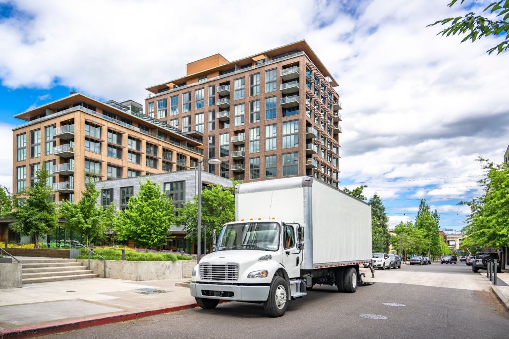 Moving truck parked outside of a high rise apartment building