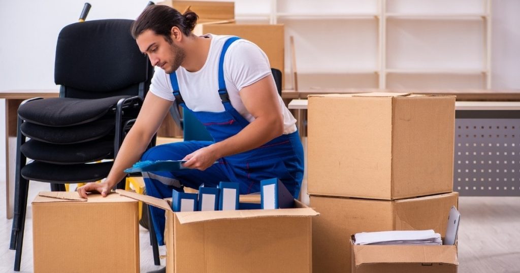 A professional with a moving company in Livingston NJ packing boxes